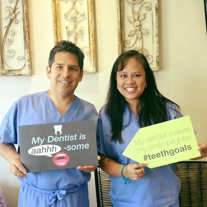 Dr. Castro and Dr. Hipona with dental goals signs