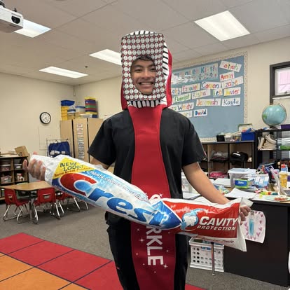 Community education with toothbrush costume and Crest tube
